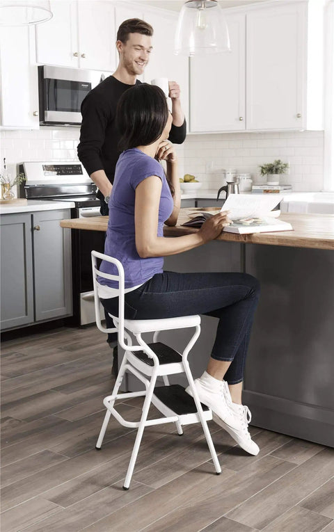 Retro Style Chair And Flip Up Step Stool In White With Vinyl Seat And Steel Frame in kitchen scene with two people interacting.