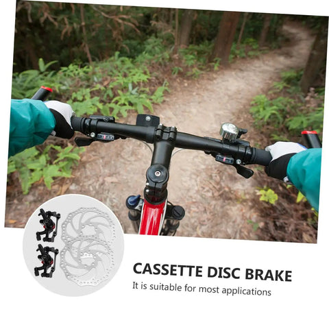 Top Shelf Front And Rear Disc Brake Rotor Kit For Mountain Bikes With Silver Aluminum Build 160mm Diameter Mechanical Setup Dual Knob Adjustment To Legit Crush Every Gnarly Trail, view from handlebars on trail.