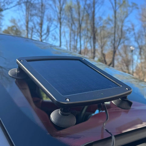 Five Watt Solar Panel 12V Battery Charger With Charge Controller IP67 Weatherproof mounted on car windshield with suction cups