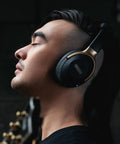 Person wearing black Spark NEO Wireless Guitar Headphone Amp And AI Powered Guitar Rig For Dope Audio Experience With Custom Audio Drivers.