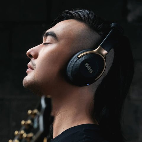 Person wearing black Spark NEO Wireless Guitar Headphone Amp And AI Powered Guitar Rig For Dope Audio Experience With Custom Audio Drivers.