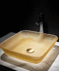 USZWBY Yellow Square Shape Tempered Glass Bathroom Vessel Sink with Waterfall Tap Modern Artistic Vessel Sink with Pop Up Drain, Counter Top Installation on marble surface.