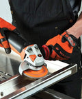 Worker using Enduro-Flex Stainless Flap Disc Ceramic Abrasive 4-1/2 Inch Diameter 7/8 Inch Arbor Grit 40 on metal surface