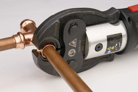Close-up of ProPress tool crimping 12 Pack 1/2 Inch Copper Press Fittings Kit for leak-free water piping installation.