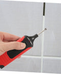 Hand uses tool from Tile Repair Kit For Porcelain And Marble Color Wax Blocks For Quick Scratch Chip Repair on tile grout.