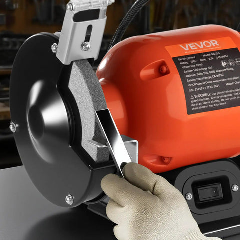 Badass Six Inch Bench Grinder With 3450 Rpm Single Speed Motor And Dual Grit Grinding Wheels paired with LED work light for sharpening.