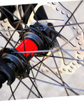 Fire Up Your Rig With This Mountain Bike Front And Rear Mechanical Disc Brake Kit Featuring Forged Aluminum Calipers Premounted Pads And Direct Pull Cables For Solid Stops On Wild Trails All Season Long with a close-up of a disc brake rotor and hub.