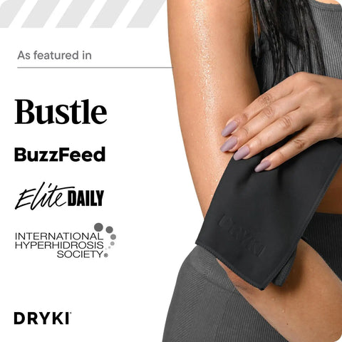 Woman using pocket sized sweat towels for face hands and body on the go quick dry microfiber handkerchiefs in black.