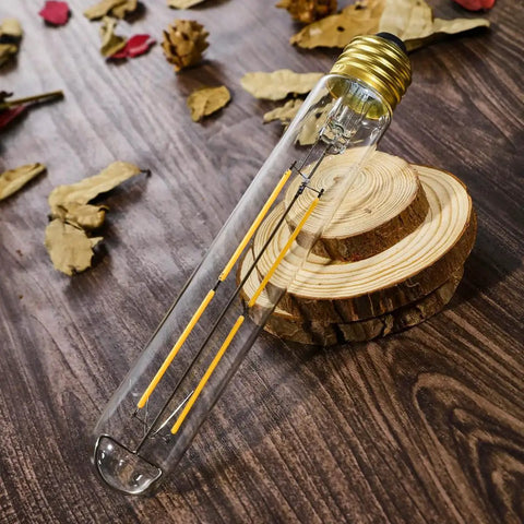 Dimmable E26 LED Light Bulb 6W Equal 60W Incandescent, clear tube design on wooden surface, with decorative leaf accents