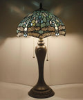 Lit Tiffany Style Sea Blue Dragonfly Stained Glass Table Lamp with light on, 12 inch shade, 22 inch tall, antique green bronze base