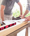 Two people working with Foldable 28 Inch Magnetic Level With 45 90 180 Bubble Angles, Pro Grade Hinged Measuring Tool on a wooden surface