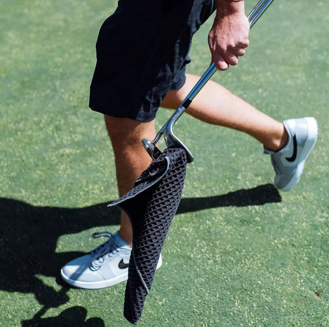 Golfer carrying club with Premium Magnetic Golf Towel With Brush Groove Cleaner And Clip Microfiber Waffle Towel for your golf bag