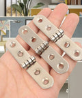 Heavy Duty Iron Folding Door Hinges 6 Pack With Rust Resistant Finish For Furniture And Decor Easy Install Rugged And Durable Tough As Nails Door Hardware Built To Last For Cabinets And Wardrobe Use, shown held in a hand