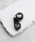 Black Aluminum Derailleur Hanger With Bolts KP419 K33049 M12x1 For Cannondale Slate Synapse Topstone on white surface