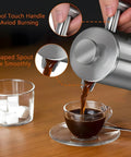 Super Thick French Press Coffee Maker Double Wall Insulated Stainless Steel pouring coffee into a glass cup with spoon.