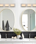 Everett 24 Inch Modern 3 Light Integrated LED Vanity Light With Brushed Nickel Finish above twin mirrors in bathroom.