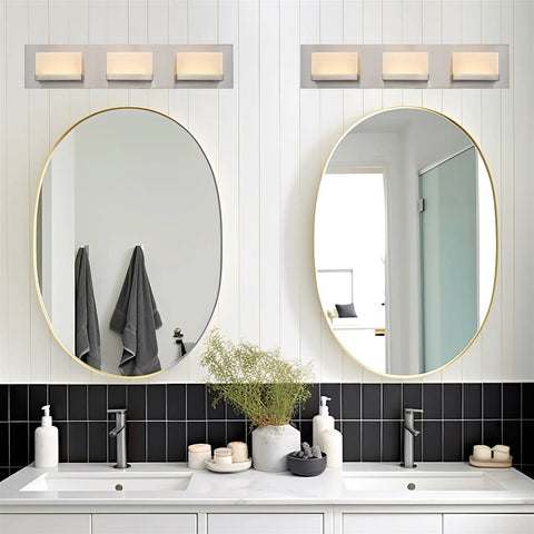 Everett 24 Inch Modern 3 Light Integrated LED Vanity Light With Brushed Nickel Finish above twin mirrors in bathroom.