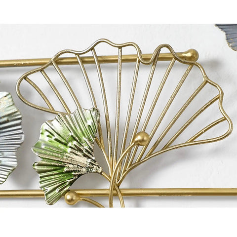 Close-up of decorative gold wall mounted coat rack with green leaf design, part of Heavy Duty Wall Mounted Coat Rack With Sturdy Hooks For Draping Jackets Hats And Outerwear In The Entryway Hallway Bedroom A Simple Setup That Keeps Your Daily Gear Straight Up Tidy.