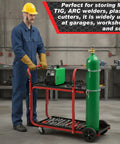 Heavy Duty Two Tier Welder Cart For TIG Arc MMA Plasma Cutters Up To 440 Lbs, black and red with tank safety chains, in use.