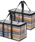 Heavy Duty Clear Storage Bins 2 Pack Extra Large Clothes Organizers With Lids stacked with folded clothes inside.