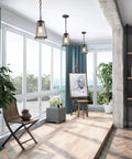 Modern Farmhouse Pendant Light For Kitchen Island In Bronze Finish With Seeded Glass Shade hanging in a sunlit living space