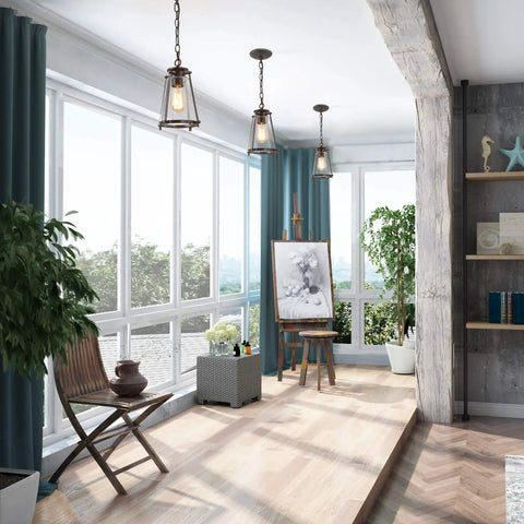Modern Farmhouse Pendant Light For Kitchen Island In Bronze Finish With Seeded Glass Shade hanging in a sunlit living space