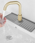 Must Have 3 In 1 Sink Splash Guard With Silicone Faucet Drip Catcher Tray Soap Dish And Sponge Holder For Kitchen RV And Bar Faucets 14.4 By 5.4 Inches Grey installed showing water flow