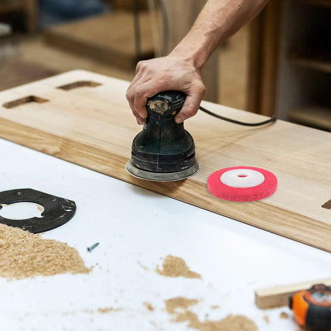 Person using a sander with red Nylon Buffing And Polishing Wheels For Plastic And Wood With Efficient High Speed Grinding Non-Woven Abrasive Discs For Auto Maintenance At Home.