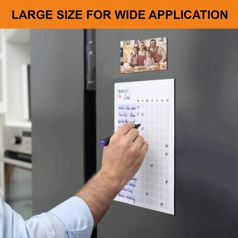 Person using Heavy Duty Magnetic Sheets With Adhesive Backing For Photos And Stickers 12 By 8.5 Inch A4 Large Cuttable Magnet Sheets Extra Strong Durable Fridge And Cabinet Magnets 4 Pack on fridge