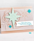 Handmade card with Must Have Christmas Scrapbooking Die Cuts Set featuring stars and snowflakes on beige background