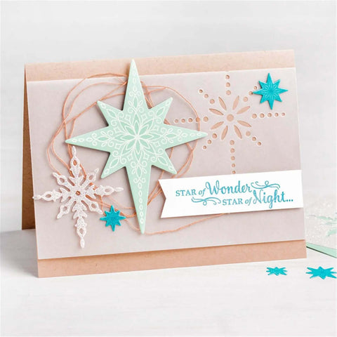 Handmade card with Must Have Christmas Scrapbooking Die Cuts Set featuring stars and snowflakes on beige background