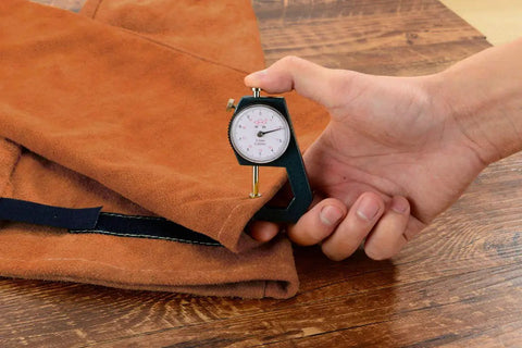 Measuring thickness of brown leather welding sleeve with Kevlar stitching; extra thick split cowhide. Leather Welding Sleeve For Men And Women, Heat And Flame Resistant Arm Protection With Kevlar Stitching And Cotton Lining, Extra Thick Split Cowhide, One Size Fits Most, Brown.