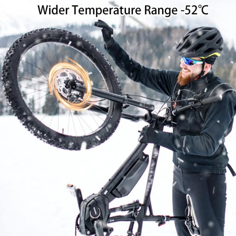 Cyclist in snow highlighting Two Bottle Pack Mineral Oil Brake Fluid for Shimano Tektro TRP Hydraulic Disc Brakes, wider temperature range.