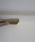 Hand using Extra Large Drywall Sanding Sponge With Fine And Medium Grits for rough and finish sanding on ceiling surface.