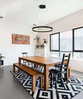 Slick Modern LED Chandelier With Remote Control, 60W Black Ring Ceiling Light in a dining room, 3000K to 6000K dimmable.