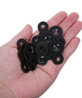 Hand holding black heavy duty iron table top fasteners with screws, dual hole design joining plates for wall mount and picture frames.