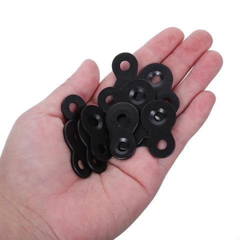 Hand holding black heavy duty iron table top fasteners with screws, dual hole design joining plates for wall mount and picture frames.