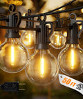 Outdoor String Lights 50ft Connectable Patio Lighting With 52 G40 LED Bulbs Warm White 2200K shining in a garden setting