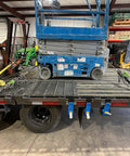 Flatbed with Hi Viz Green Beefy Heavy Duty Folding Handle Ratchet Load Binder securing scissor lift, 7100 lbs WLL.