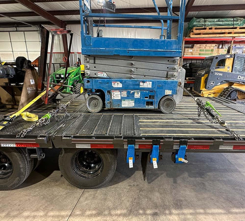 Flatbed with Hi Viz Green Beefy Heavy Duty Folding Handle Ratchet Load Binder securing scissor lift, 7100 lbs WLL.