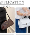 Brown leather shoulder bag and light gray handbag, both with heart turn-lock closures.