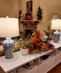 Blue Ceramic Table Lamp With White Fabric Shade Chinoiserie Urn Style Hand Painted Detail alongside autumn decor on a sideboard