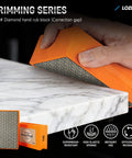 Diamond hand rub block being used on marble surface, showcasing durability and grip.