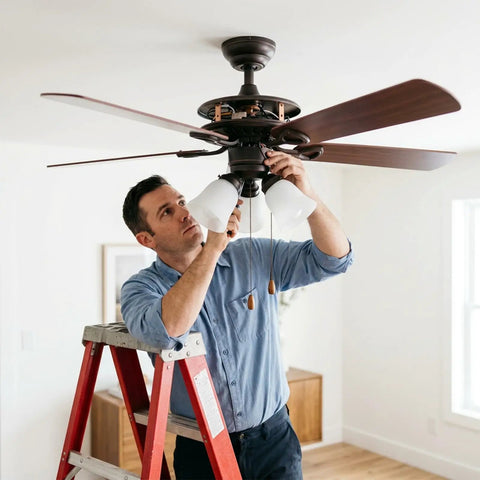 Man installing Rock Solid 30 Piece Full Replacement Ceiling Fan Blade Screws With 1/4-20 Threading And Premium Bronze Pan Heads.