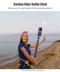 Heavy Duty Carbon Fiber Selfie Stick Extends To Super Long 118 Inches With Reliable 1/4 Inch Mount held by woman on beach.