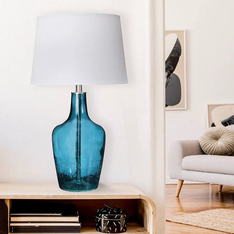 Cool Deep Blue Translucent Textured Glass Table Lamp With Cream Empire Shade And Brushed Chrome Accents displayed in living room