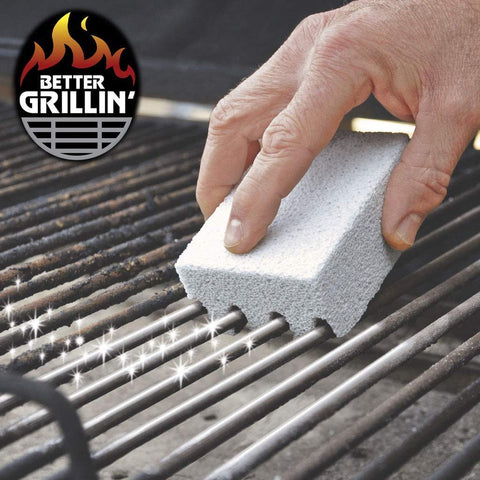Hand using Grillin Stone Grill Cleaning Brick Block for BBQ Griddle and Racks Easy Scrubbin Stone Cleaner on barbecue grill grates