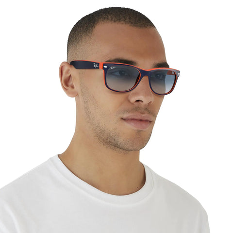 Man wearing RB2132 New Wayfarer Gradient Sunglasses Unisex Small Fit Blue On Orange Frame With Clear Gradient Blue Lenses 55mm