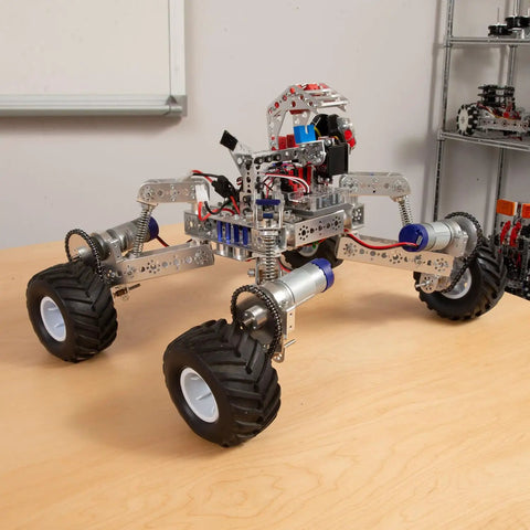 Robotic vehicle with All Terrain Tire Kit For TETRIX MAX Robotics, showing monster truck style wheels and foam inserts for rough surfaces.