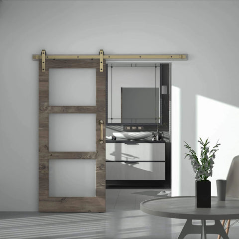 Brass Sliding Barn Door Hardware Kit In Brushed Gold Finish installed on wood door in modern interior